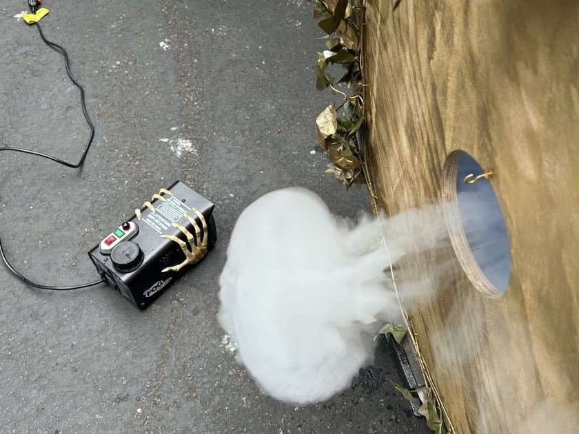 Overhead view of fog venting through the mirrored 6-inch orifice, fog machine and extension cord alongside
